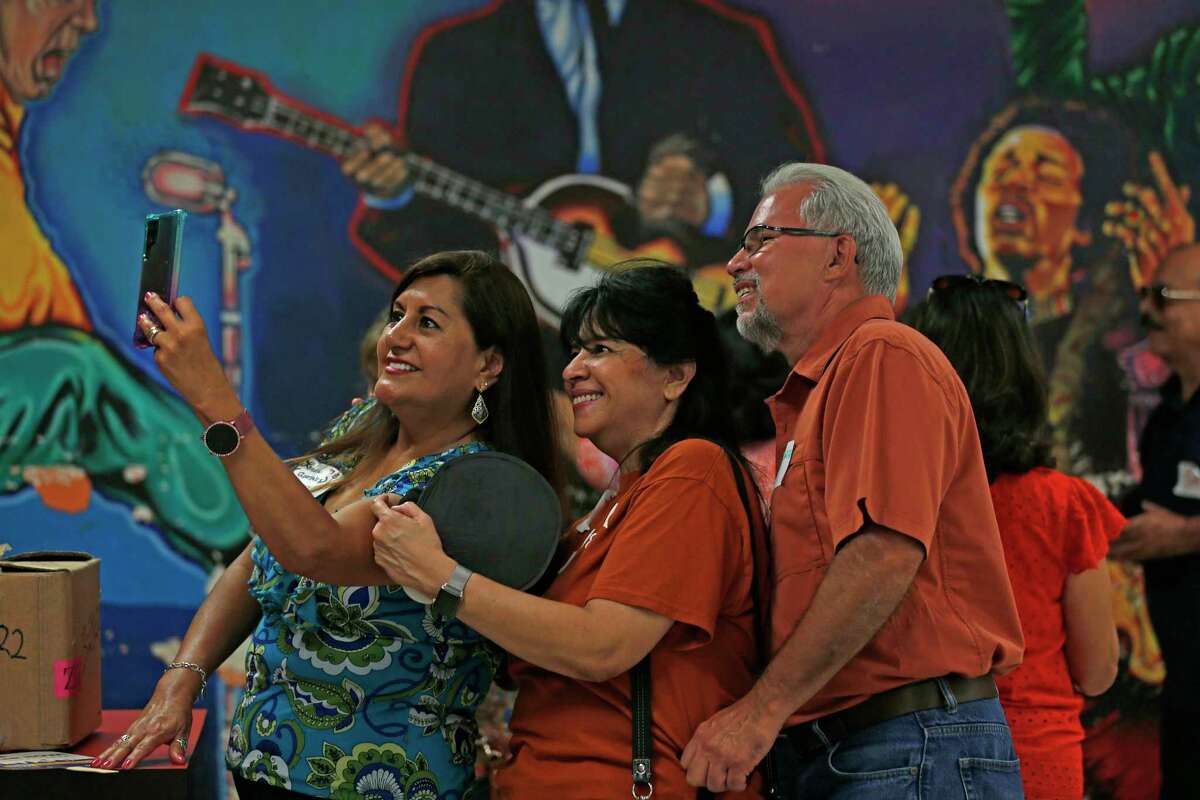 Linda Chavez, class of 1978, takes a selfie with Andy and Mary Garza as alumni and community members take a final walk through San Antonio ISD’s Burbank High School, before it’s demolished.