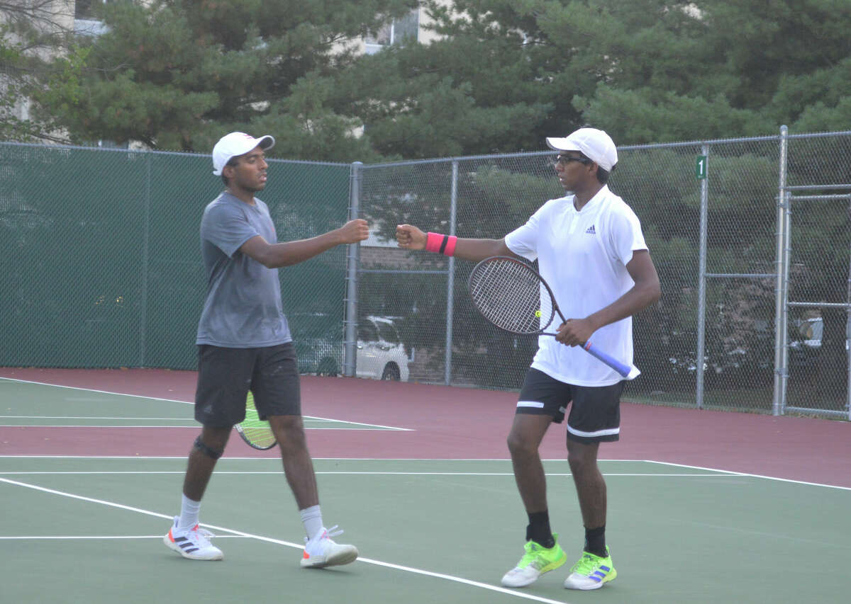 Brothers Nishanth Basavareddy and Nishesh Basavareddy celebrate after a point during the finals of the Doubles Shootout on Saturday at the EHS Tennis Center. 