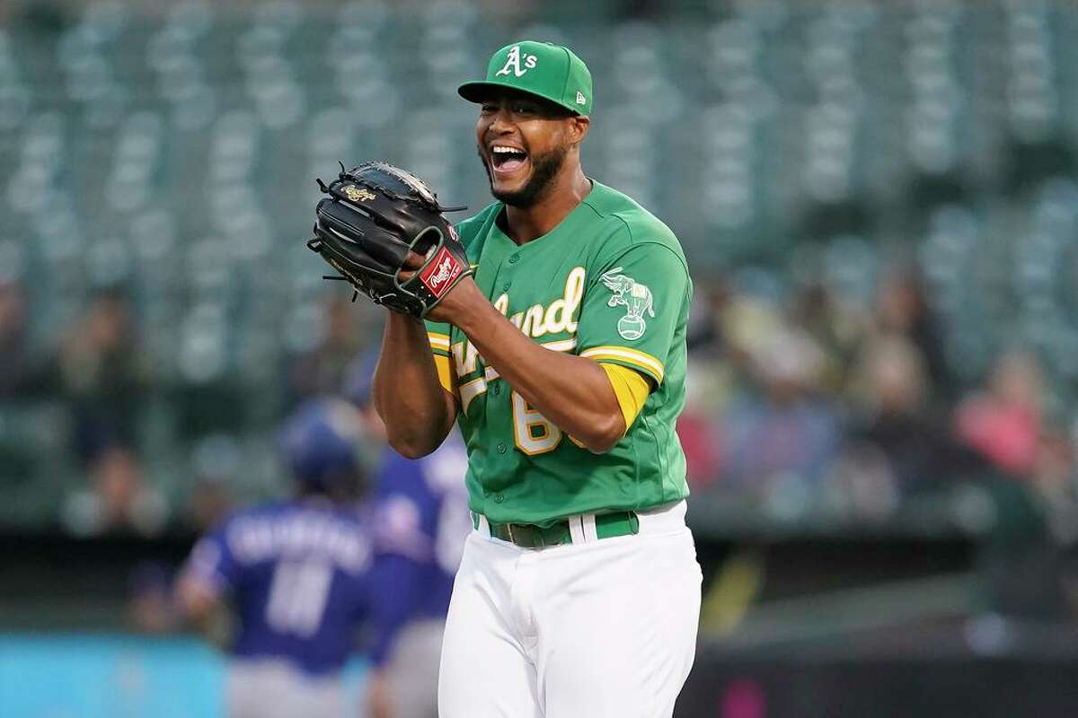 Oakland Athletics pitcher Domingo Acevedo reacts after Texas Rangers' Charlie Culberson hit into a double play to end the top of the sixth inning of a baseball game in Oakland, Calif., Saturday, July 23, 2022. (AP Photo/Jeff Chiu)