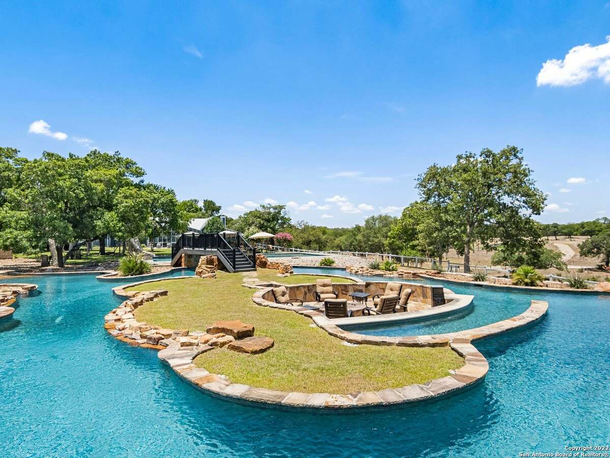 A 5,026-square-foot home with a junior Olympic size swimming pool, resort-style lazy river and swim up bar and fire pit just north of Boerne is on the market for $7.8 million. 