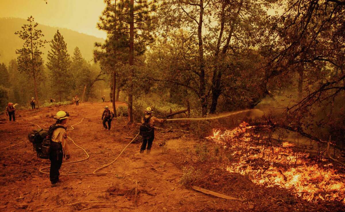 Firefighters battle the Oak Fire in unincorporated Mariposa County, Calif., on Sunday, July 24, 2022.