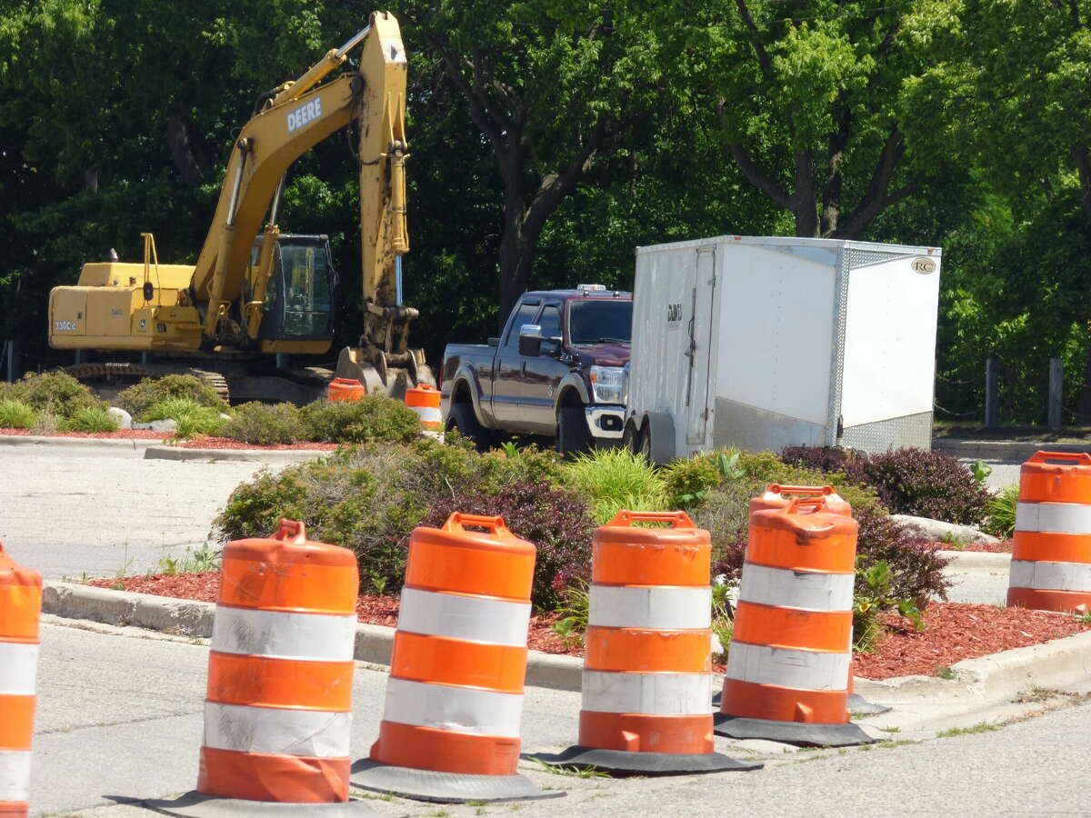 An excavator and other equipment is readied for work at Memorial Drive in Manistee.