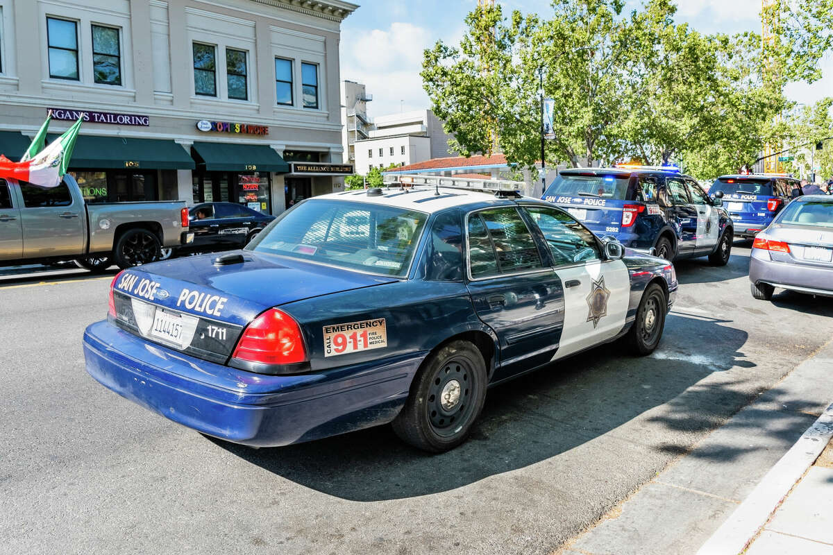 San Jose Police vehicles stopped on a street in downtown.