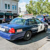 San Jose Police vehicles stopped on a street in downtown.