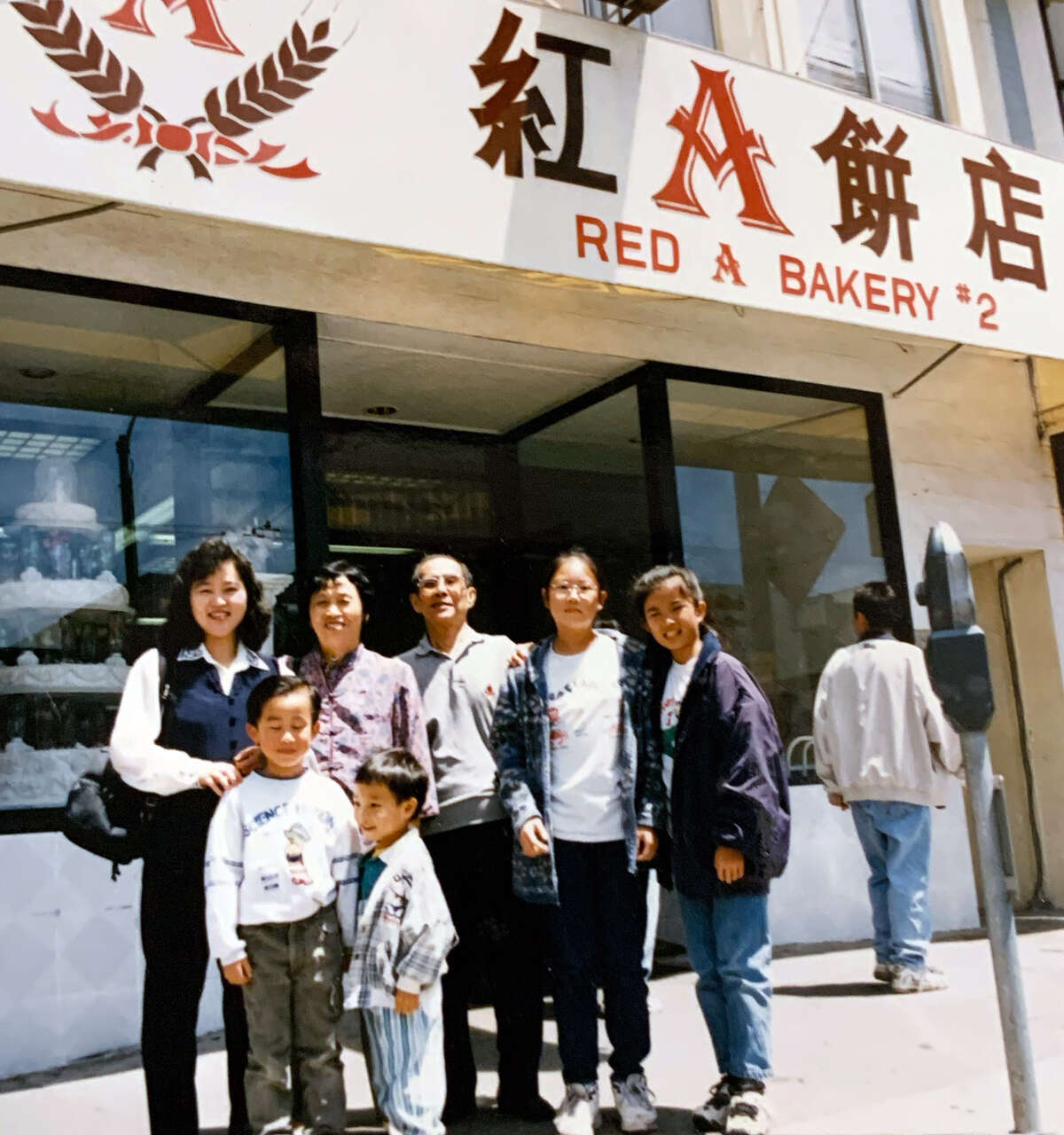 The Yu family standing in front of the Clement Street location of their family business, Red A Bakery, in the mid-1990s.
