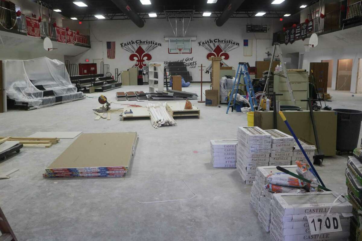 Faith Christian Academy's gym floor has been turned into a storage area for wallboard and other supplies as the school repairs water damage as it prepares for the start of school on Aug. 8.