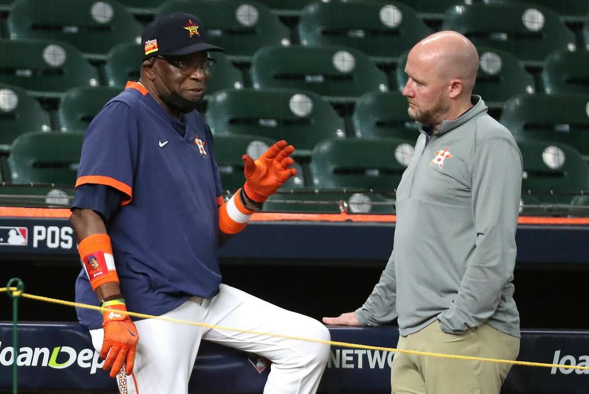Manager Dusty Baker, left, and GM James Click talk near the Astros' dugout during a workout prior to the 2021 American League Championship Series.