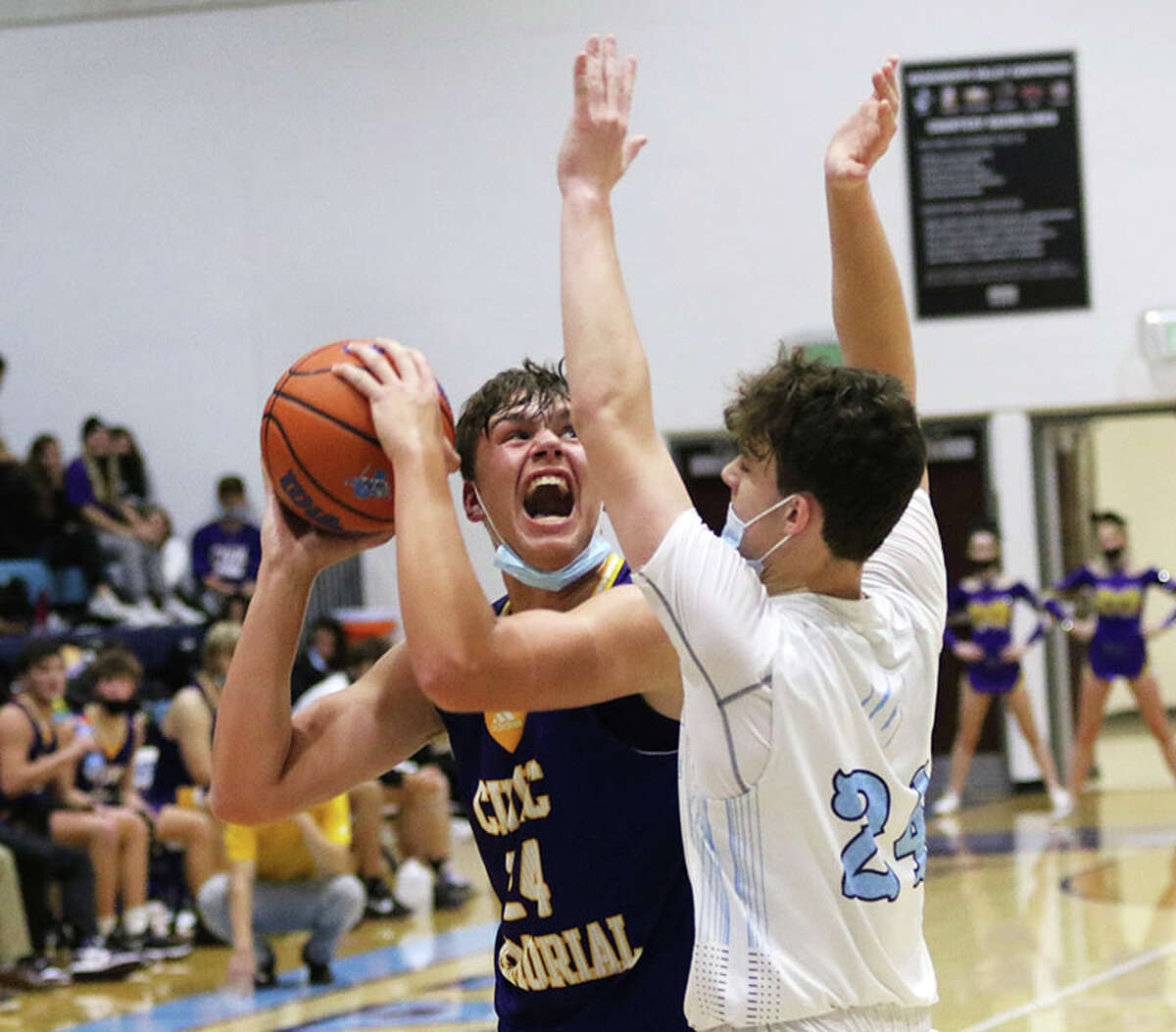 CM junior Sam Buckley (left) looks to shoot over Jersey's Ayden Kanallakan in a MVC game last December in Jerseyville. Buckley is the 2022 Telegraph Large-Schools Boys Basketball Player of the Year.