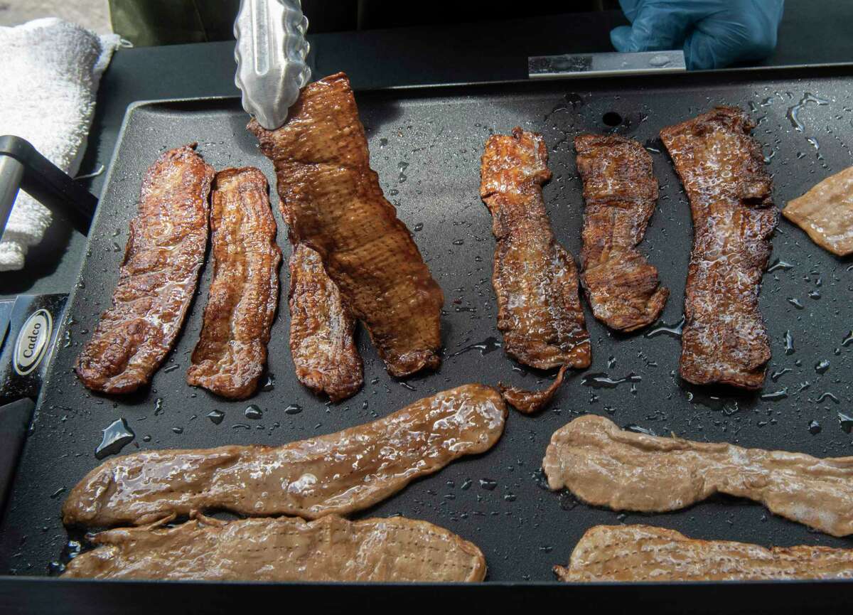 Bacon made out of mycelium by the company MyForest Foods sizzles on a fry pan during a factory tour event at Ecovative on Monday, July 25, 2022 in Green Island, N.Y. MyForest Foods which makes MyBacon is an affiliate of Ecovative.