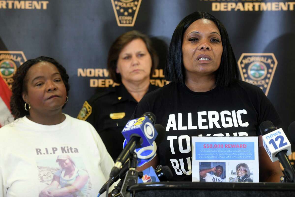 April Barron, right, of Bridgeport, mother of Iroquois Alston, speaks during a news conference at Police Headquarters, in Norwalk, Conn. July 26, 2022. Alston was shot and killed along with Rickita Smalls in Norwalk in August of 2011. Their murders remain unsolved.