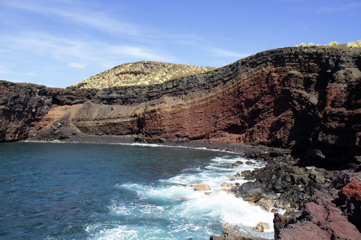 A large cinder cone along the coastline of Pohue.