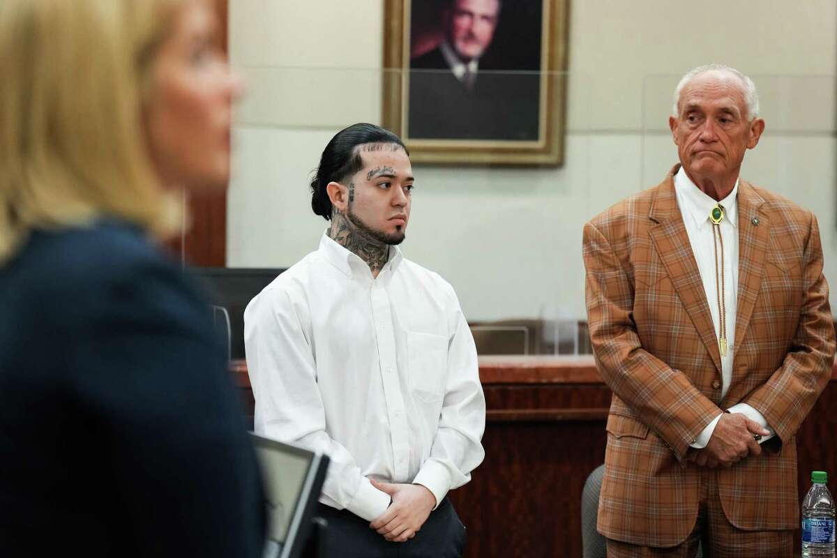 Robert Soliz stands alongside his attorney Paul Looney as the jury is brought into the courtroom for opening arguments in his trial Tuesday, July 26, 2022 in Houston. Soliz is accused of killing HPD Sgt. Sean Rios in November 2020.