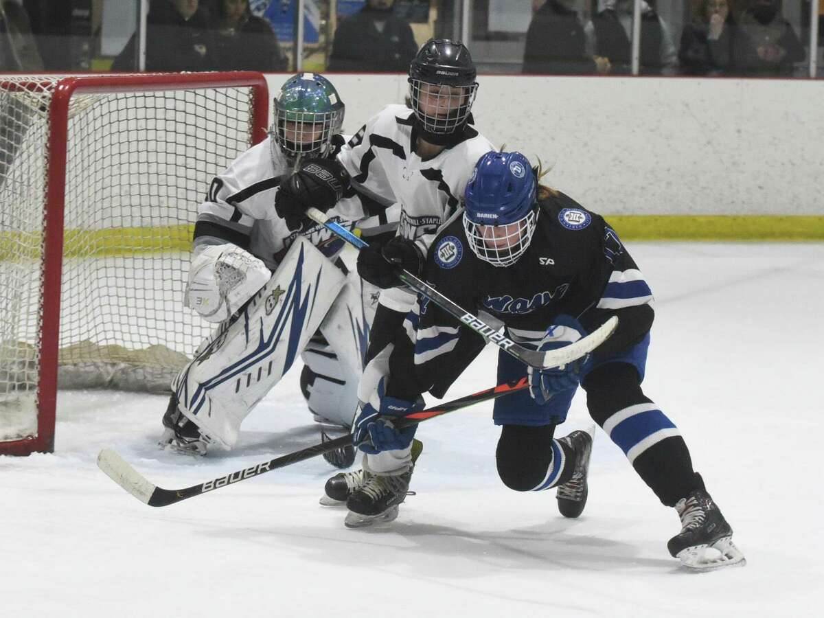Stamford-Westhill-Staples goalie Sydney Butler and Maya Sherman (18) defend the net against Darien’s Morgan Massey (17) during the FCIAC semifinals on Feb. 23.