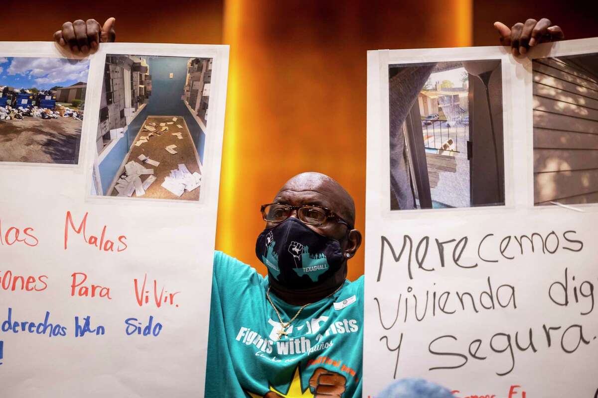 TOP organizer Oscar Thomas holds protest signs during a City Council meeting at City Hall in downtown Houston on Tuesday, July 26, 2022.