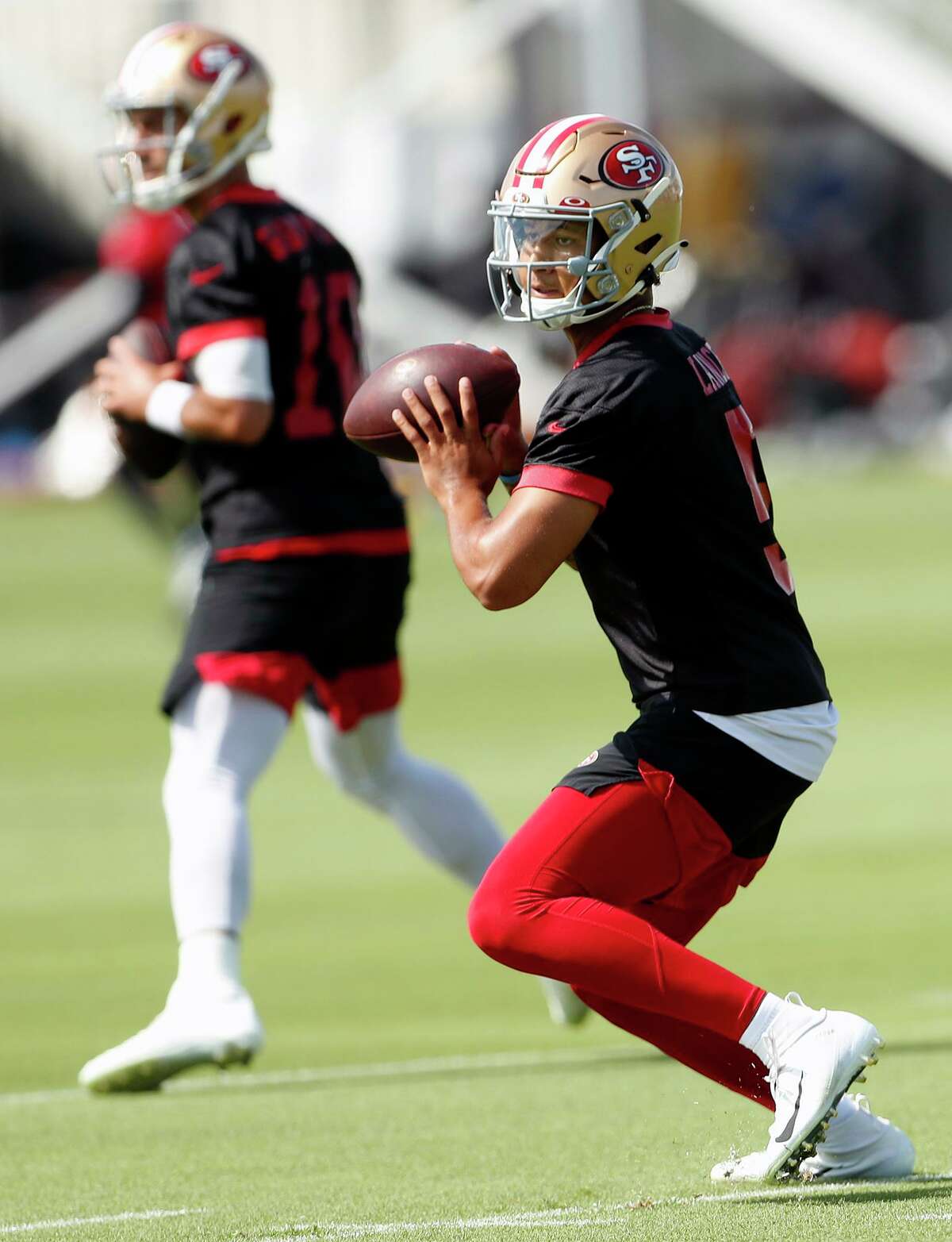 San Francisco 49ers' Trey Lance (5) and Jimmy Garoppolo (10) during training camp at Levi's Stadium practice field in Santa Clara, Calif., on Wednesday, July 28, 2021.