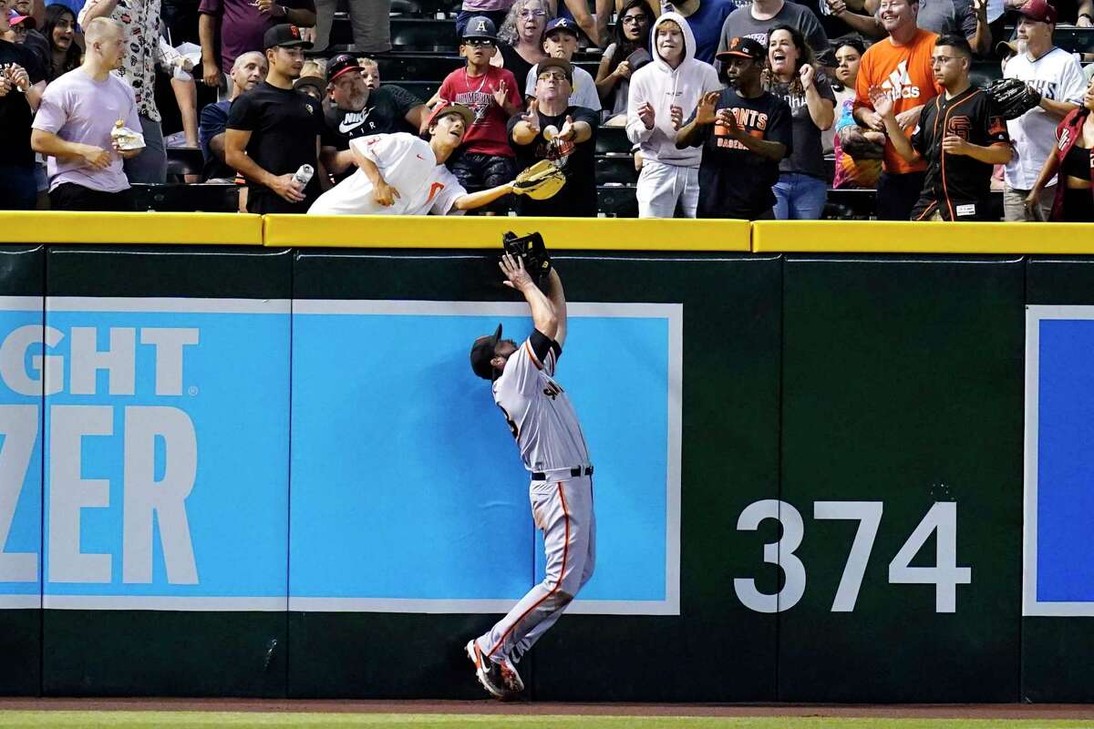 San Francisco Giants left fielder Darin Ruf is unable to make a play on a two-run home run hit by Arizona Diamondbacks' Sergio Alcantara during the second inning of a baseball game Tuesday, July 26, 2022, in Phoenix. (AP Photo/Ross D. Franklin)