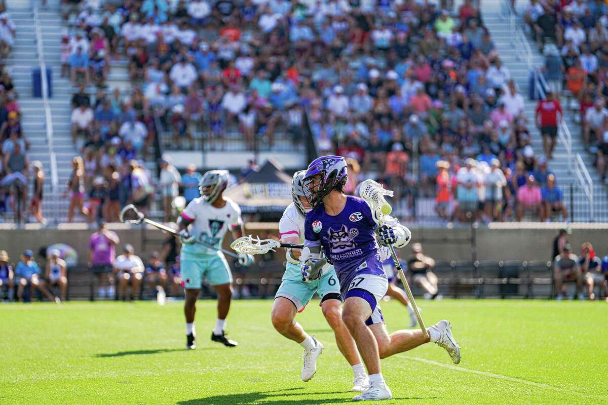 Ethan Walker of the Waterdogs goes up against the Chrome defense during a Premier Lacrosse League game in front of a large crown at Fairfield University’s Rafferty Stadium on Sunday.
