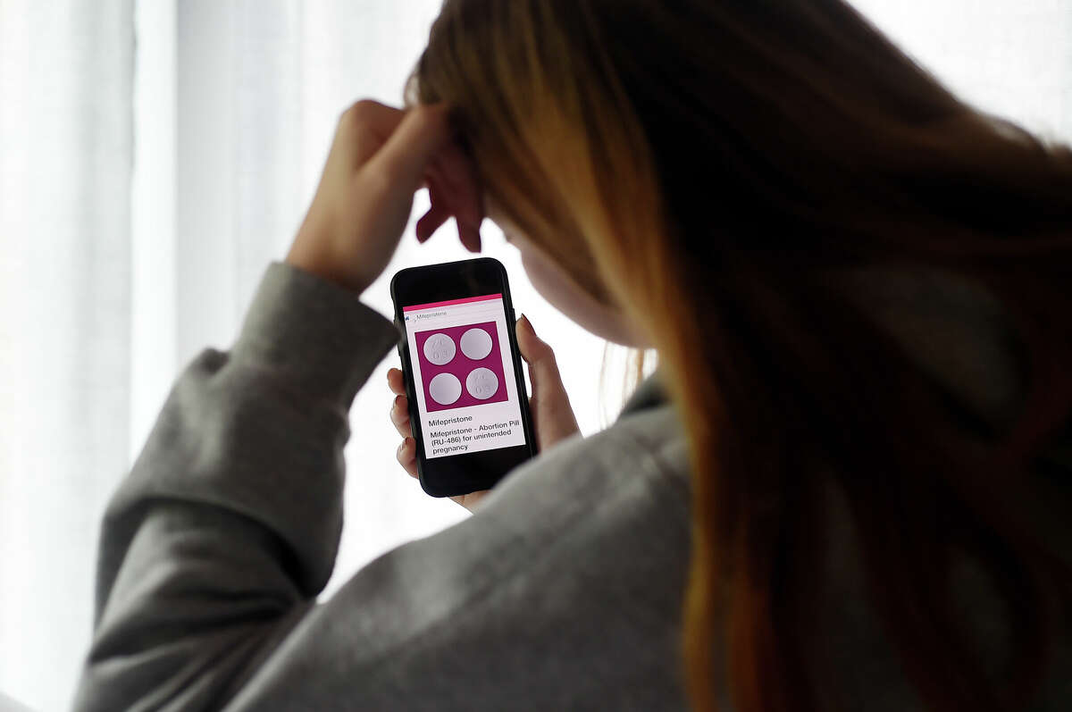FILE PHOTO A person looks at an Abortion Pill (RU-486) for unintended pregnancy from Mifepristone displayed on a smartphone.
