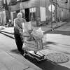An assistant from DeRose's Grocery pushes a shopping cart in front of Satan's Pool Parlor in 1978. Today, the restored building is home to Gather East Rock.