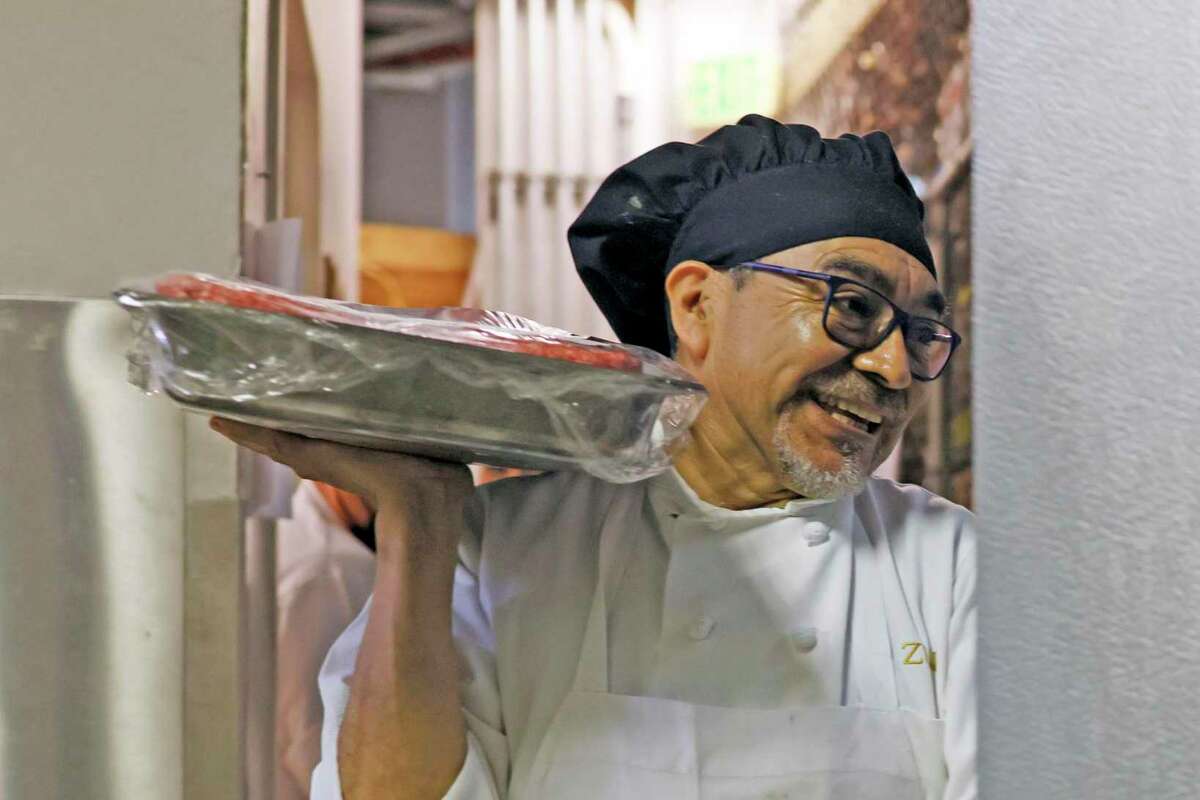 Carlos Garcia stores meat at Zuni Cafe, Thursday, July 21, 2022, in San Francisco, Calif.