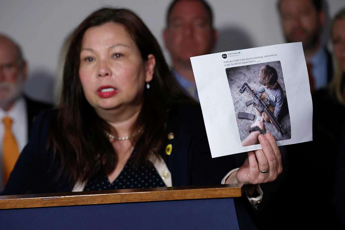 WASHINGTON, DC - JULY 20: Sen. Tammy Duckworth (D-IL) holds up advertisements from Daniel Defense while talking to reporters following a hearing about the mass shooting in Highland Park, Illinois, and civilian access to military-style weapons in the Hart Senate Office Building on Capitol Hill on July 20, 2022 in Washington, DC. An 18-year-old man shot and killed seven people and injured dozens of others in Highland Park when he opened fire on a July 4th parade from a nearby rooftop using and AR-15 style assault rifle. (Photo by Chip Somodevilla/Getty Images)