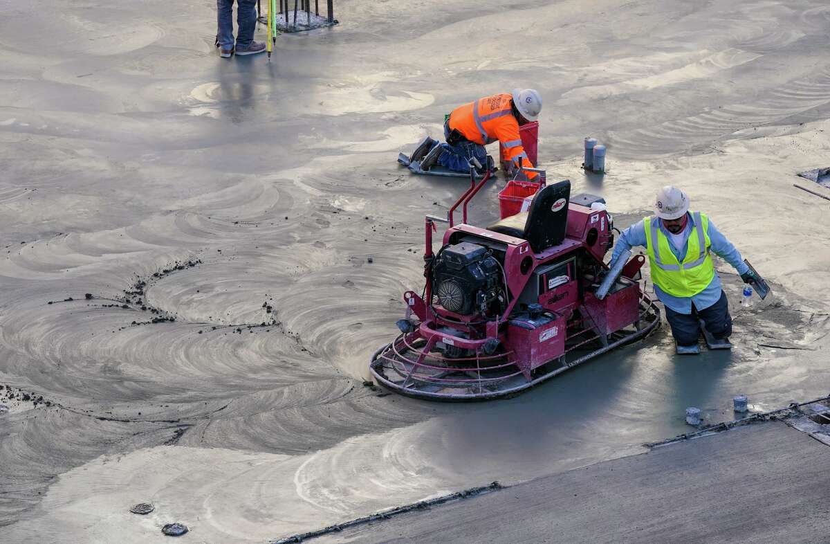 Concrete workers finish a floor during construction of the University Health Woman’s and Children’s Hospital, which is slated to open in mid-2023. The 12-story, 300-bed hospital for women, babies and children also features a 900-space parking garage. And a pediatric pharmacy will be added after University Health’s board of managers approved budget adjustments to accommodate the new project.