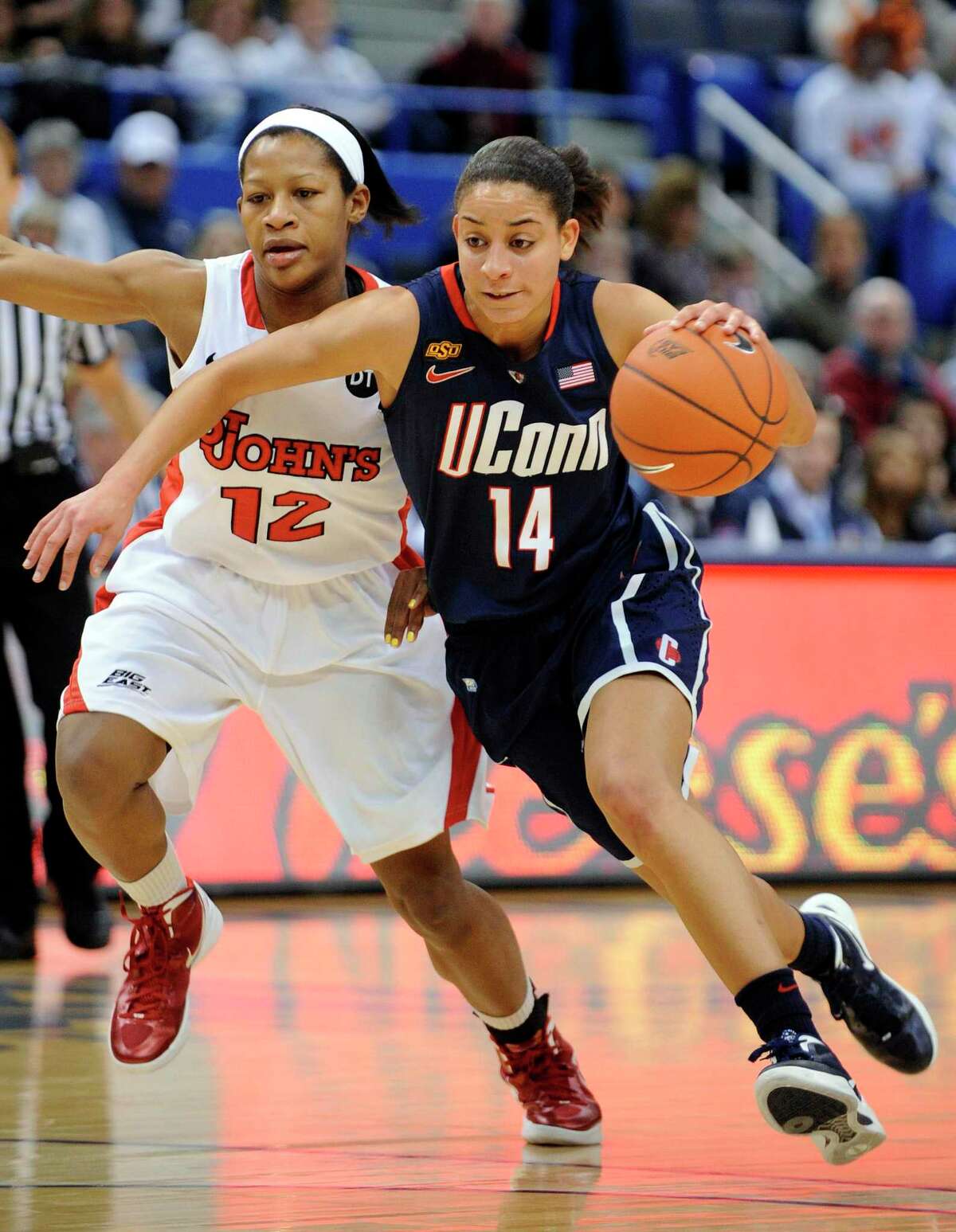 Connecticut's Bria Hartley, right, drives past St. John's Briana Brown during the first half Connecticut's 74-43 victory in an NCAA college basketball game in the semifinals of the Big East women's tournament in Hartford, Conn., Monday, March 5, 2012. (AP Photo/Fred Beckham)