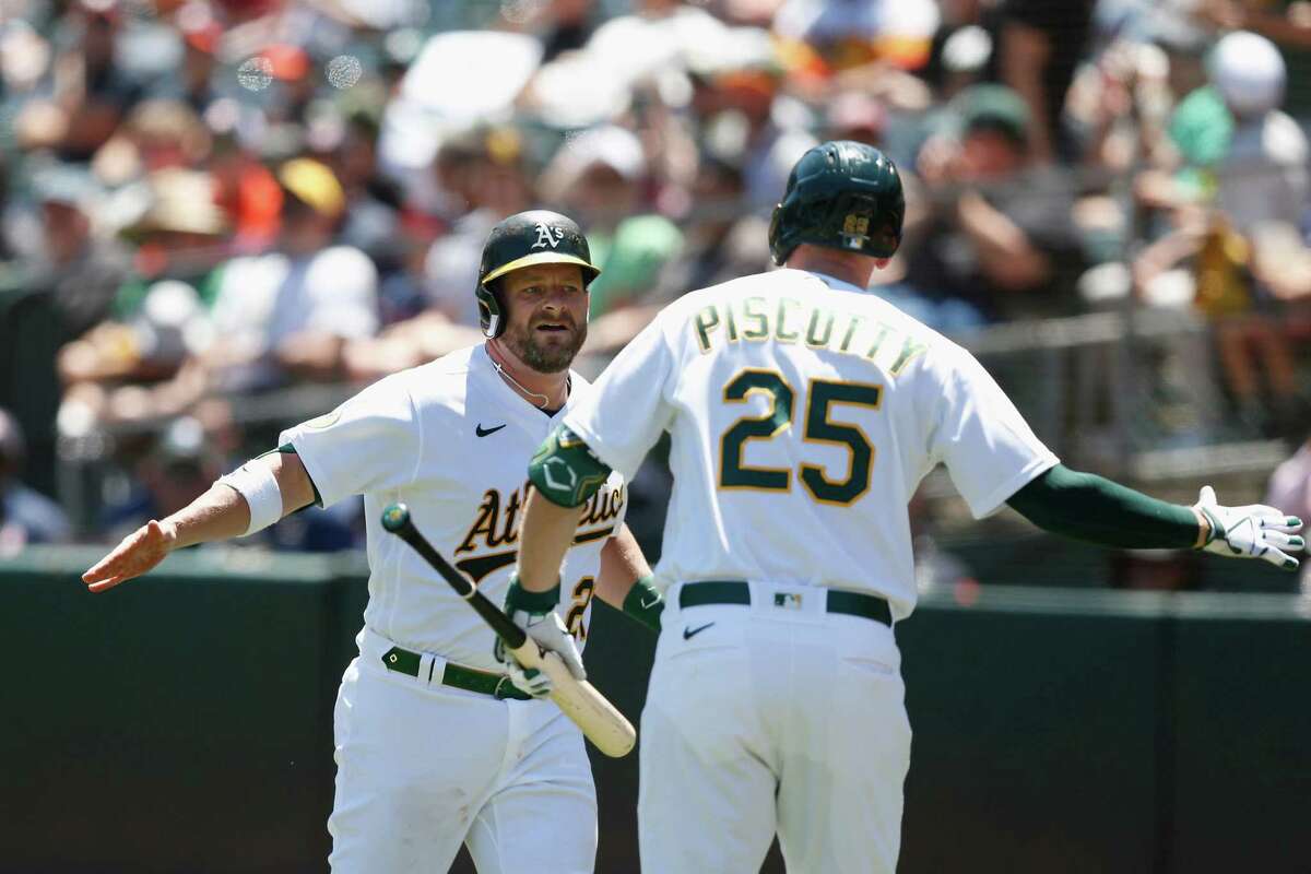 OAKLAND, CALIFORNIA - JULY 27: Stephen Vogt #21 of the Oakland Athletics celebrates with Stephen Piscotty #25 after hitting a solo home run in the bottom of the second inning against the Houston Astros at RingCentral Coliseum on July 27, 2022 in Oakland, California. (Photo by Lachlan Cunningham/Getty Images)