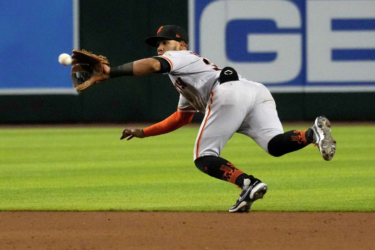 San Francisco Giants second baseman Thairo Estrada fields a grounder by Arizona Diamondbacks' Christian Walker, who was out at first during the sixth inning of a baseball game Wednesday, July 27, 2022, in Phoenix. (AP Photo/Rick Scuteri)