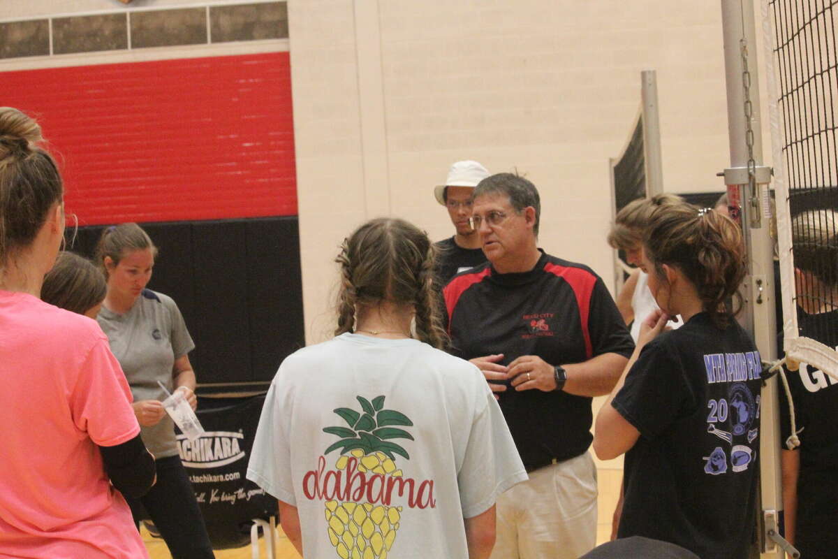 Reed City volleyball coach Don Patterson (middle) talks with his team after Tuesday's open gym.