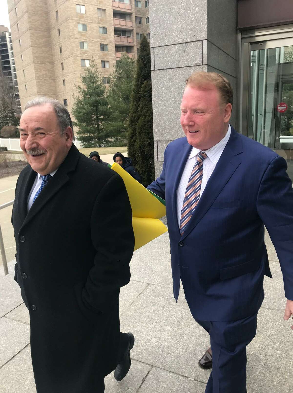 John Mallozzi (left) leaves the Stamford courthouse with his attorney, Stephan Seeger, in 2019.