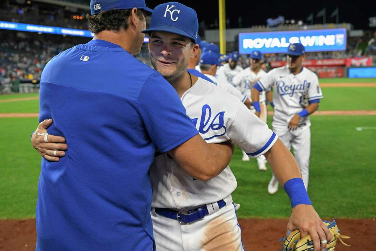 Kansas City Royals manager Mike Matheny, left, congratulates Andrew Benintendi, right, after they beat the Los Angeles Angels 7-0 in a baseball game, Monday, July 25, 2022, in Kansas City, Mo. (AP Photo/Reed Hoffmann)
