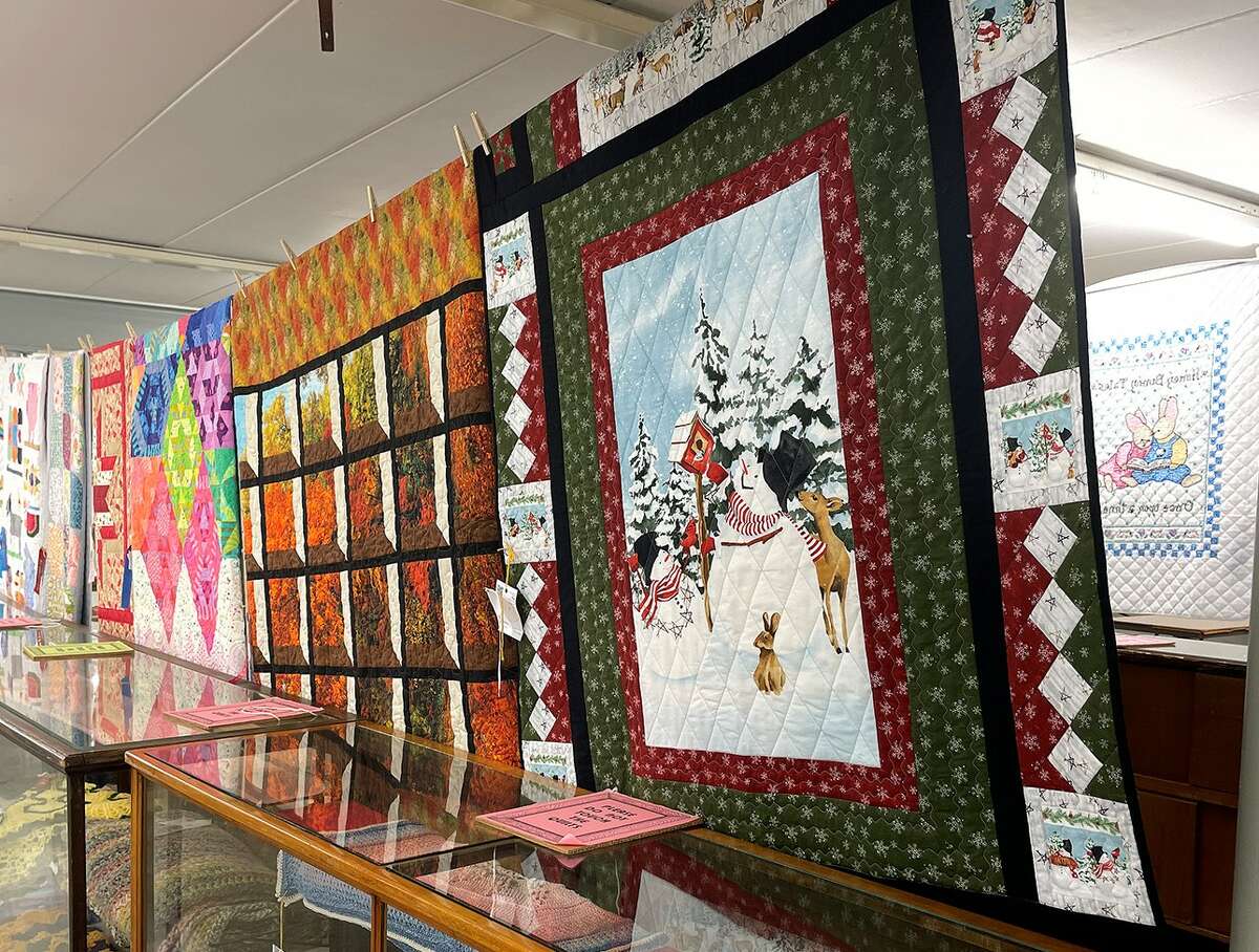Several 4-H quilts are hung for visitors of the Madison County Fair to view. Other fair projects included family trees, photography, fabric arts and artwork.