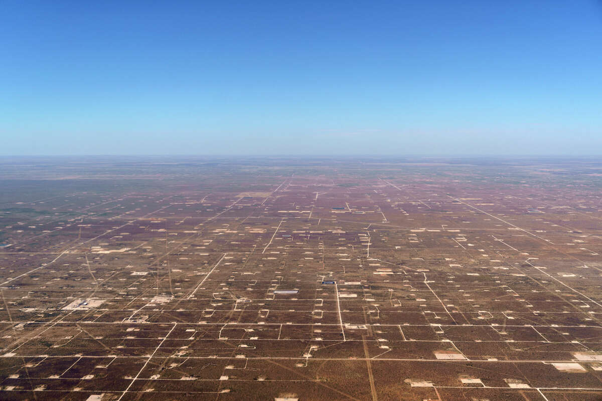 Patches of land housing oil pumpjacks dot the landscape of the Permian Basin in Midland Monday, Oct. 11, 2021. 