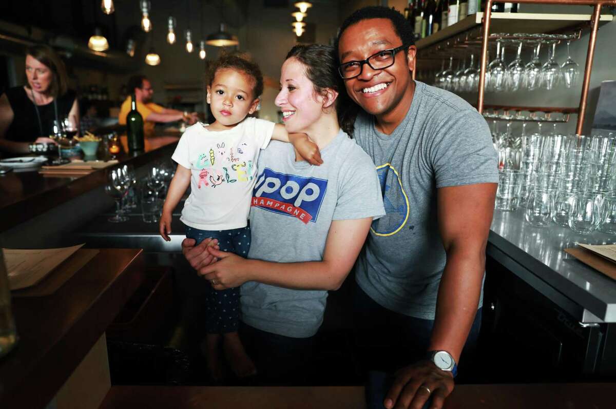 Rebecca Fineman, holding daughter Edith, and husband Chris Gaither at Ungrafted, their wine bar in Dogpatch.