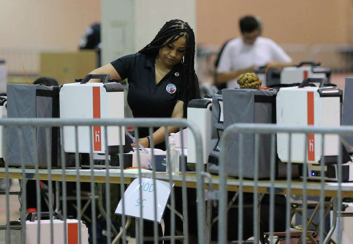 Harris County staff certifying voting equipment as it arrives the Central Count Tuesday, May 24, 2022, at NRG Arena in Houston.