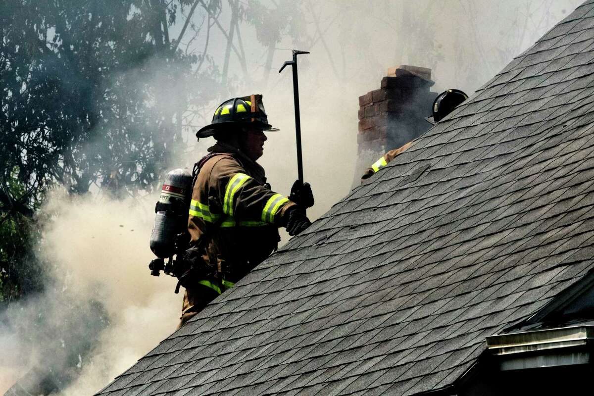 Firefighters work to extinguish a house fire at 2317 6th Ave. on Thursday, July 28, 2022 in Watervliet, N.Y. St. Peter's Health Partners has been offering free cancer screenings to firefighters.