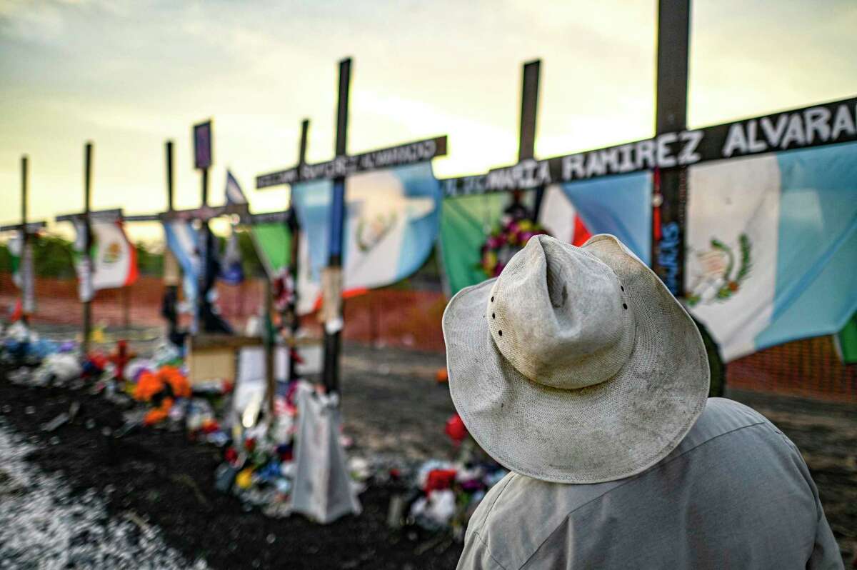 A man pays his respects on Wednesday, July 27, 2022, at the site on Quintana Road where 53 migrants died in a trailer on June 27. The migrants were from Honduras, Mexico and Guatemala. A shrine has been erected on the site.