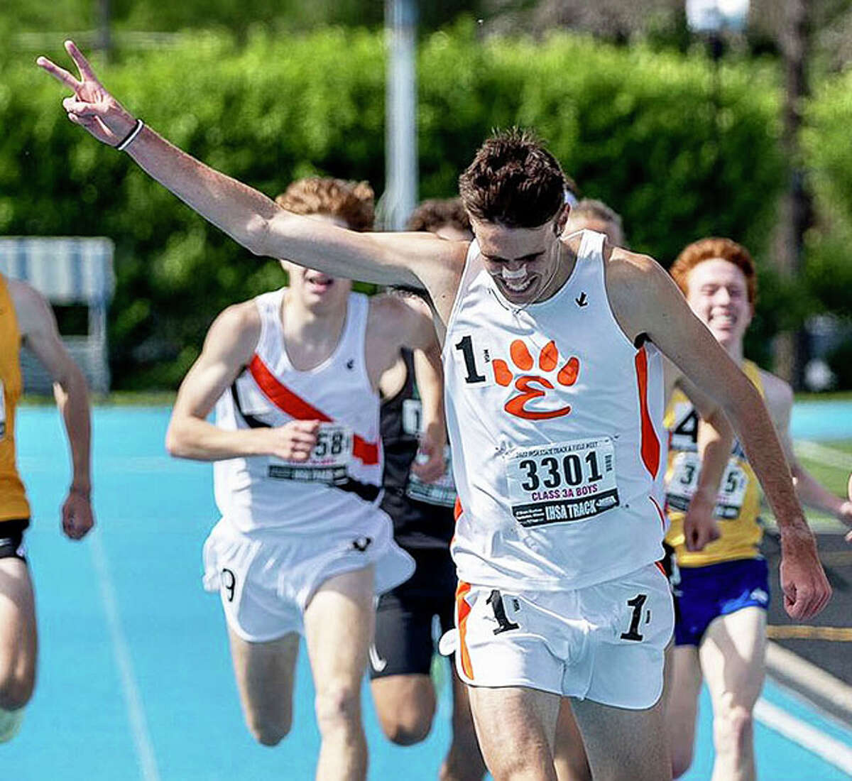 Edwardsville senior Ryan Watts holds up two fingers as he crosses to finish line in the 1,6000 meters for his second state title after winning the 3,200 earlier in the day in May's Class 3A state meet in Charleston. 