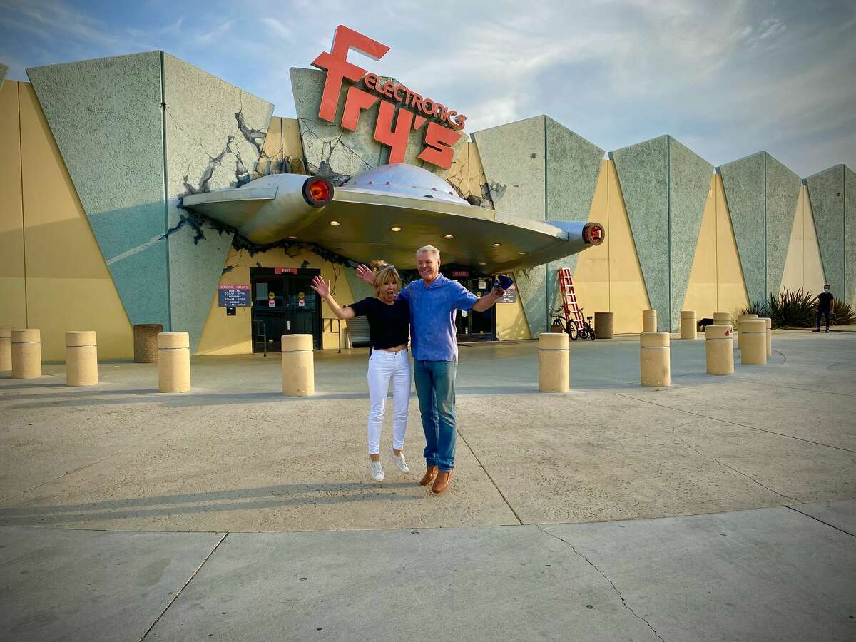 Vicki Liviakis and Randy Fry pose for a photo at the Burbank Fry's Electronics before "Nope" began filming there.