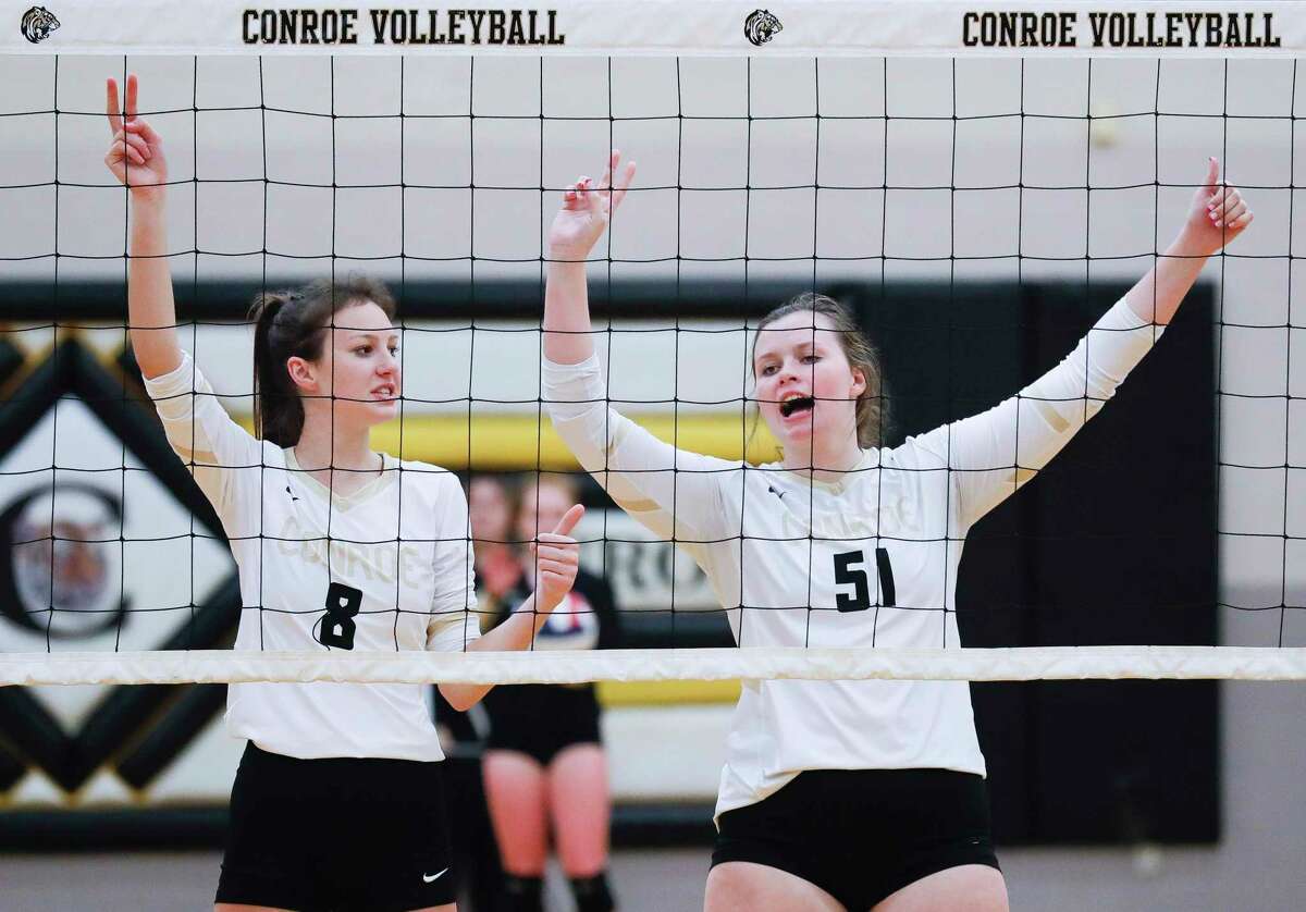 Conroe right side hitter Kaiden Medford (51) calls out the defense beside middle blocker Brooklyn Spikes (18) during the third set of a non-district high school volleyball match at Conroe High School, Wednesday, Sept. 15, 2021, in Conroe.
