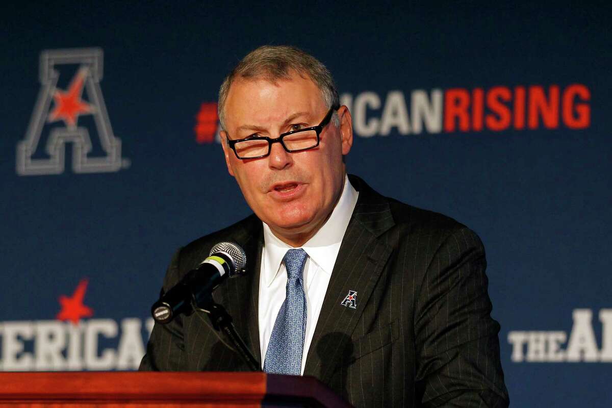 FILE - In this Aug. 4, 2015, file photo, American Athletic Conference Commissioner Mike Aresco addresses the media during an NCAA football media day in Newport, R.I. Aresco says athlete compensation, the transfer portal and conference realignment have created a perfect storm for an unsettled situation, and the American Athletic Conference commissioner believes all the FBS conferences need to have a coordinated approach to stabilize things while finding a middle ground between the lost amateur model of college athletics and increasing professionalism. (AP Photo/Stew Milne, File)
