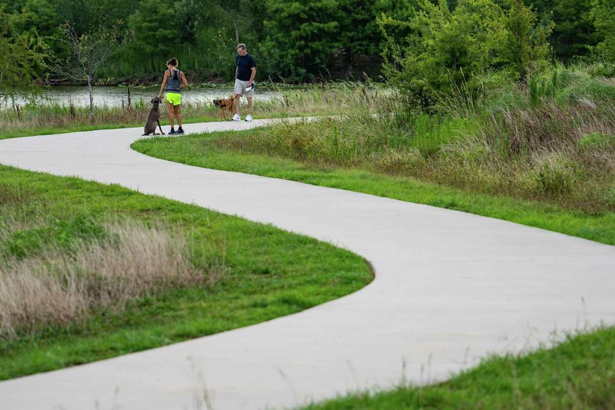 People enjoy Exploration Green, a park created on a former golf course and built in phases, Monday, July 11, 2022, in Clear Lake.