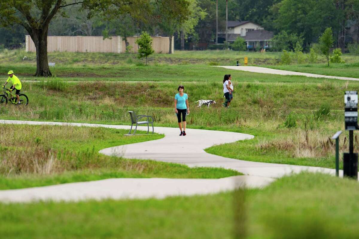 People enjoy Exploration Green, a park created on a former golf course and built in phases, Monday, July 11, 2022, in Clear Lake.