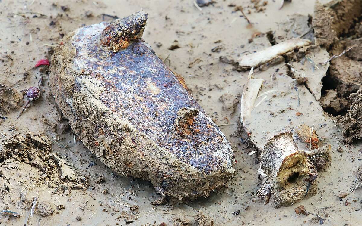 John Badman|The Telegraph What looks like part of a coffin handle lies in the mud along with what appears to be lumbar vertebrae unearthed by groundhogs in Alton City Cemetery.