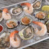 A tray of Copps Island oysters, Bloom Brothers little neck clams and shrimp cocktail served on ice at the Copps Island Oyster Shack, a new food truck and dining area at Brown's Marina in Stratford.