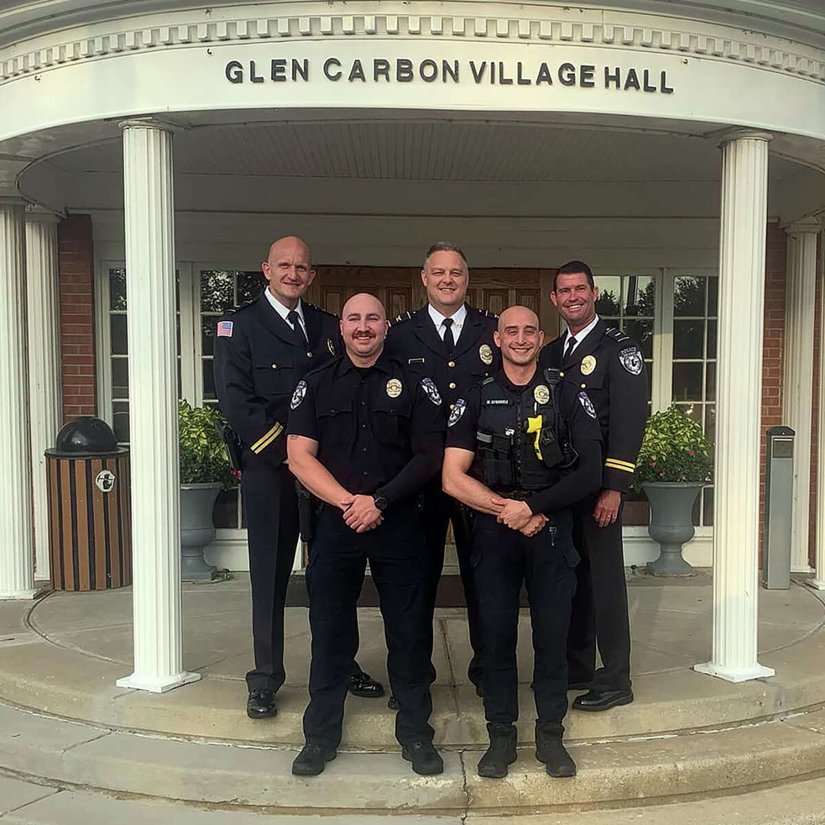 New Glen Carbon Police Officers Alex Caron and Matthew Sprankle, front row, from left to right, pose with their superiors Tuesday, back row, left to right, Lt. Ned Miller, Police Chief Todd Link and Lt. Wayne White. 