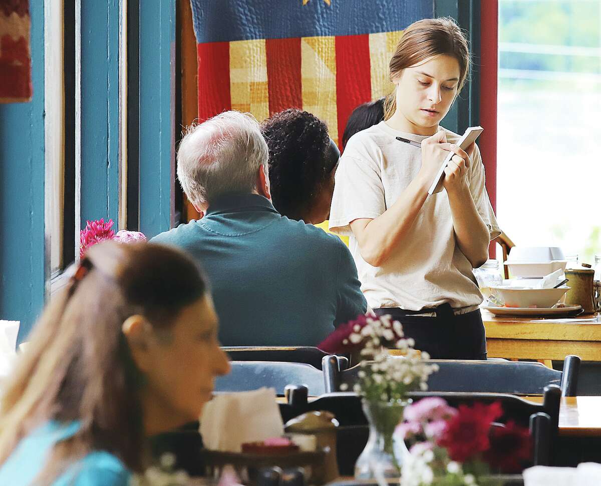 John Badman|The Telegraph Waitress Lexi Groves takes orders Thursday in the Mu Just Desserts.