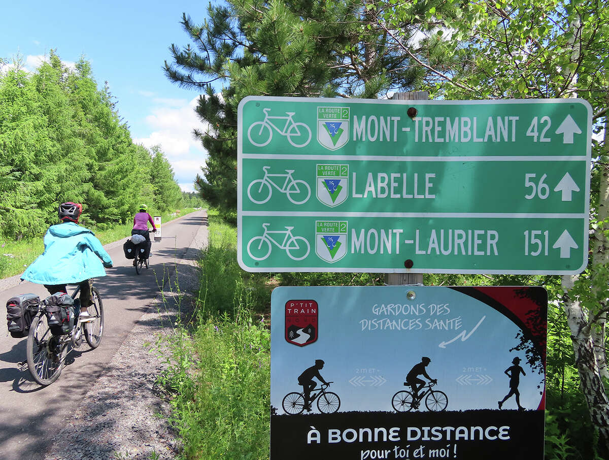 Gillian Scott and her child ride Le Petit Train du Nord outside St. Agethe des Monts, Quebec.