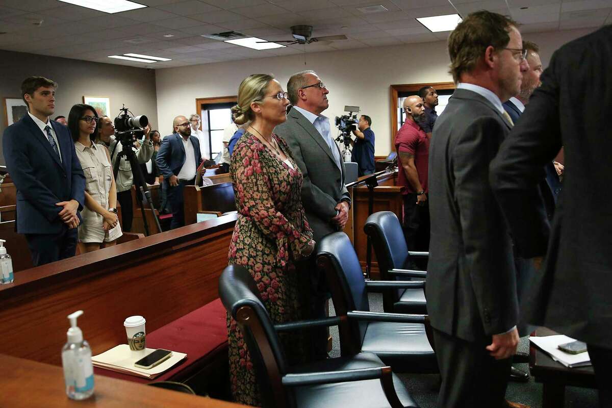 Scarlett Lewis, left, and Neil Heslin, right, the parents of 6-year-old Sandy Hook shooting victim Jesse Lewis, rise once Judge Maya Guerra Gamble begins the third day of trial Thursday, July 28, 2022, at the Travis County Courthouse. The parents are seeking two awards of $150 million from Austin-based conspiracy theorist Alex Jones in court. Jones has been found to have defamed the parents of a Sandy Hook student for calling the attack a hoax. (
